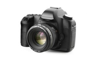 DSLR camera with mounted 50mm f1.4 lens on white background
