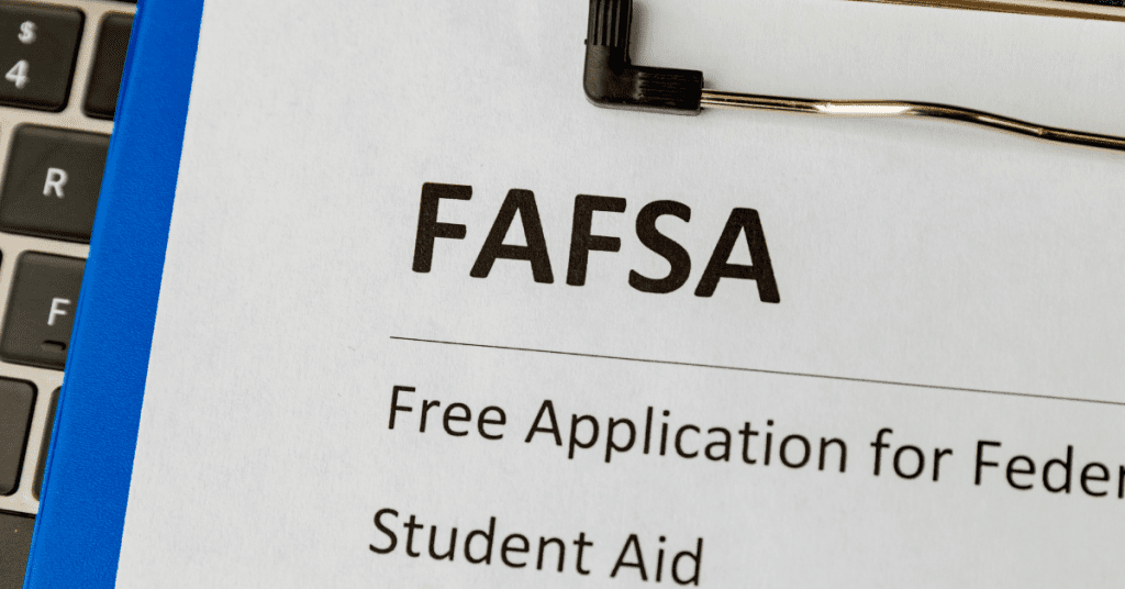 FASFA application on clipboard with computer keys in background