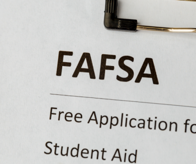 FASFA application on clipboard with computer keys in background