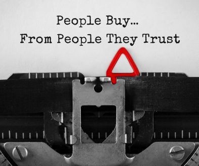 Typewriter showing "People Buy... From People They Trust" in text.