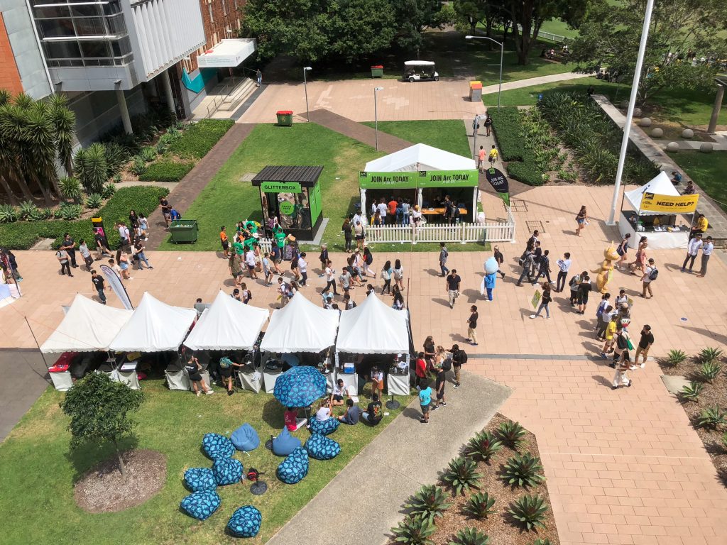 People walking in UNSW main walk during orientation week and visiting booths