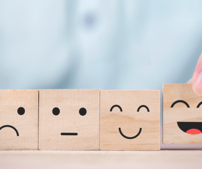 Image of four wooden blocks with various emotional faces