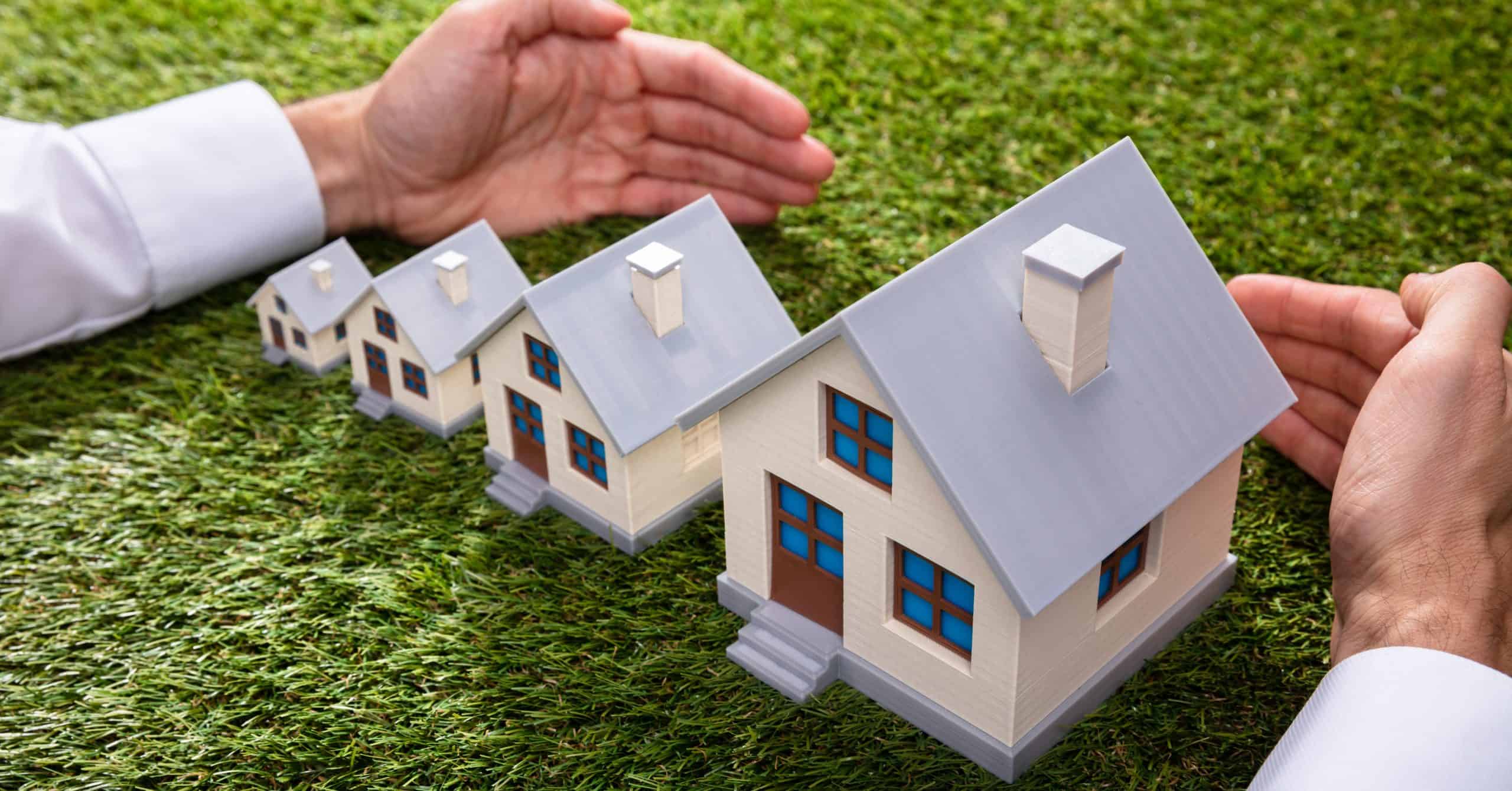 Man's hands protecting growing home sizes