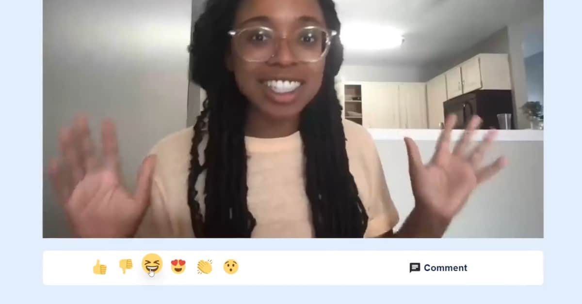 Image of a woman waving on a webcam video over a row of emojis: a thumbs up, thumbs down, laughing, heart eyes, clapping and surprised, next to a comment button